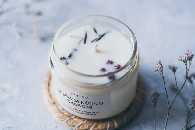 4. Close-up of BONOBO juniper scented candle with visible soy wax and essential oils, showing natural elements