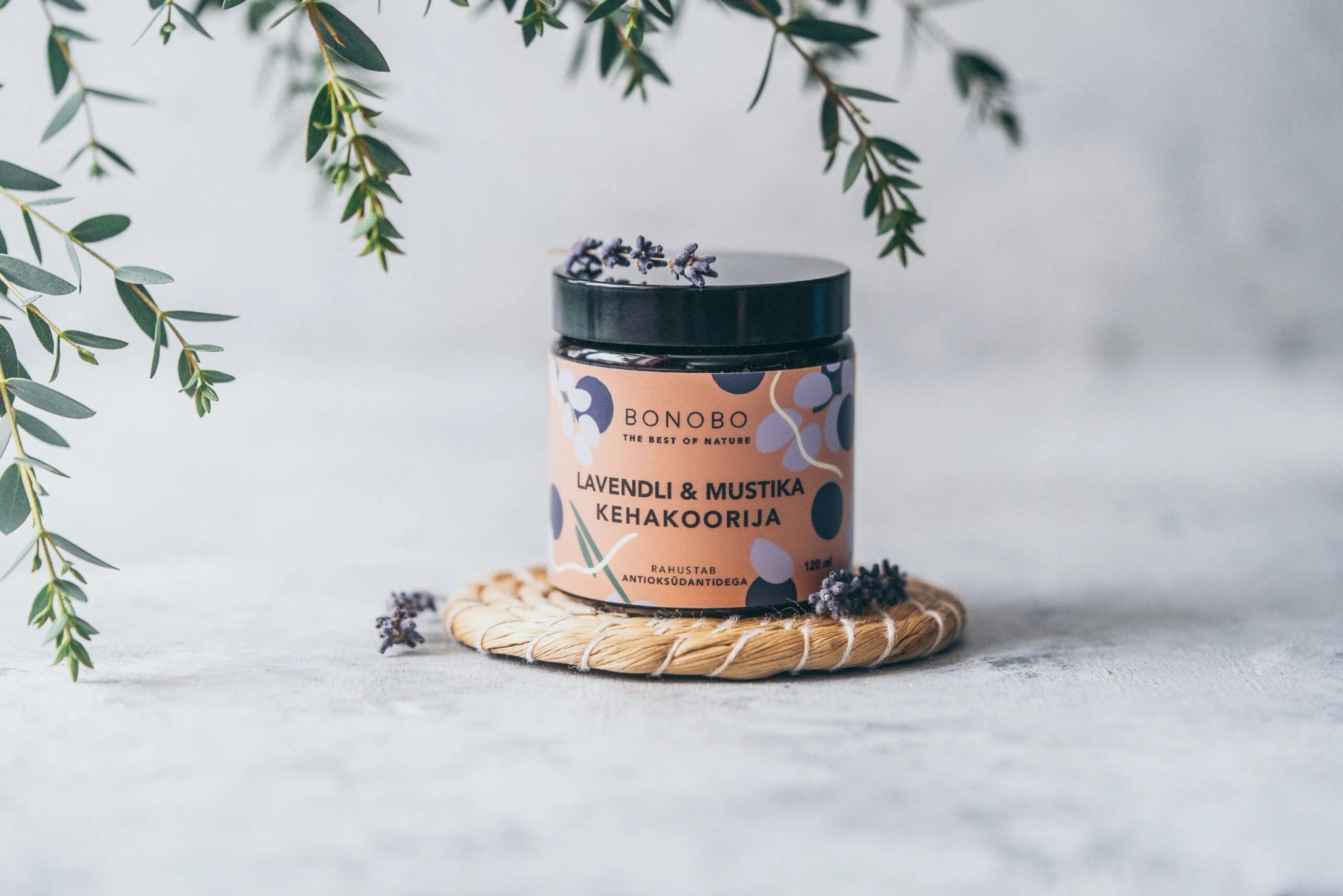 1. BONOBO Blueberry and Lavender Body Scrub jar on a woven mat with lavender sprigs, lifestyle setting