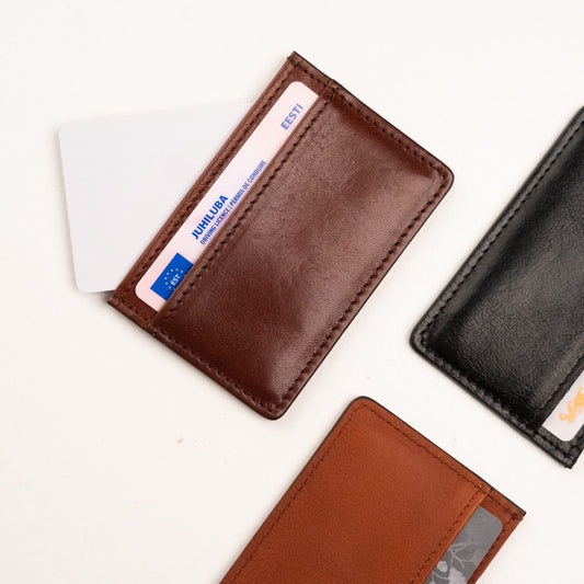1. Close-up of Papillon Leather Card Holder No. 34 in dark brown and black, showing card slots with cards inserted
