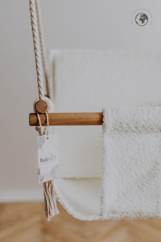 4. Close-up of bouclé snow white swing with oak wood poles and Nofi KIDS tag