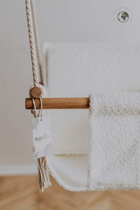 4. Close-up of bouclé snow white swing with oak wood poles and Nofi KIDS tag