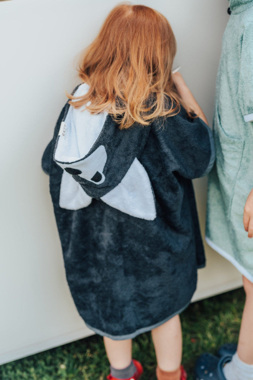 3. Back view of toddler in RÄTT WOLF Bamboo Terry Bathrobe showing hood design