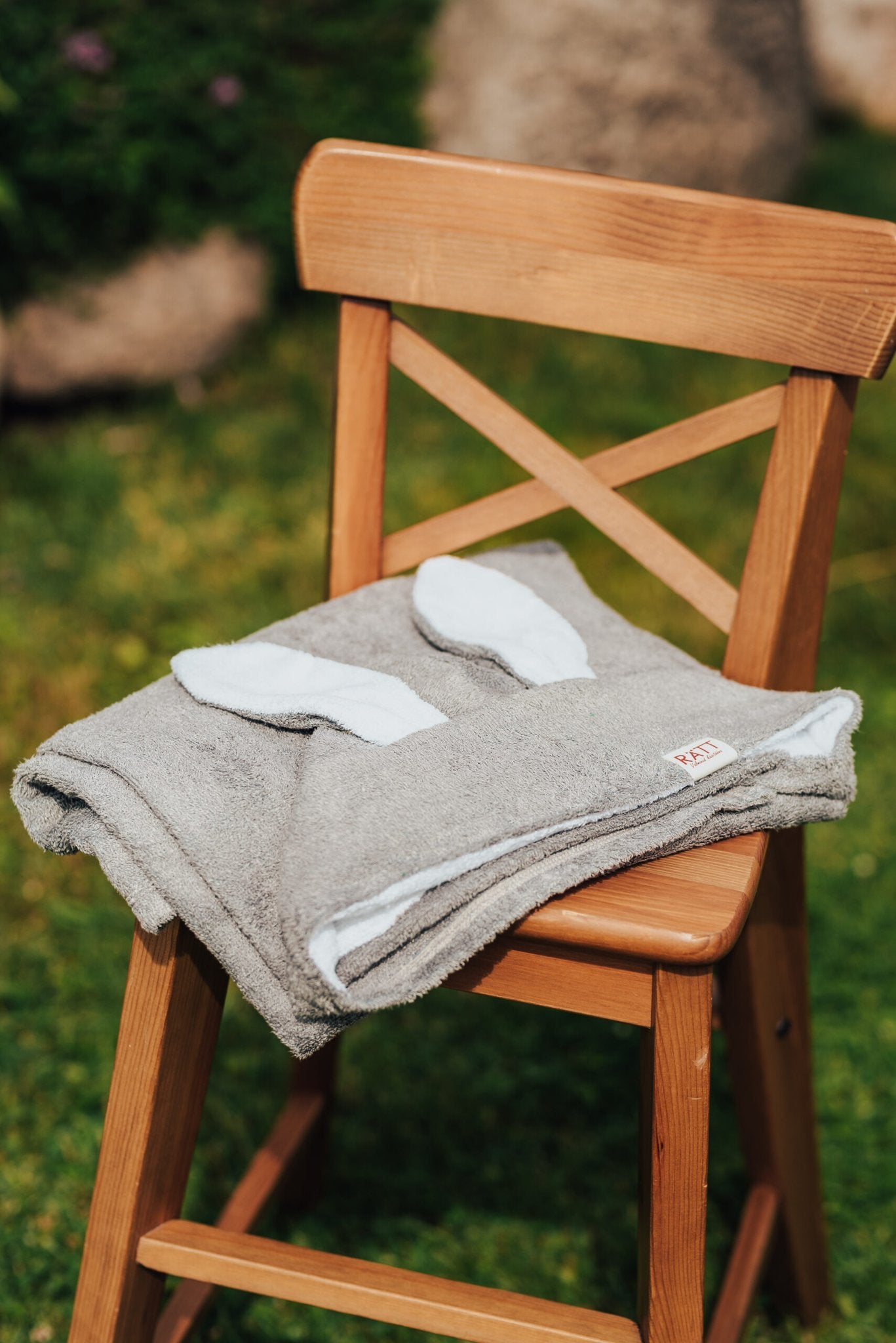 6. Gray RÄTT hooded baby bath towel with rabbit ears, folded on wooden chair