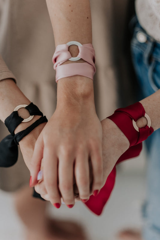 1. Women's silk ribbon bracelets in black, pink, and dark red with engraved LOVE rings, worn by models