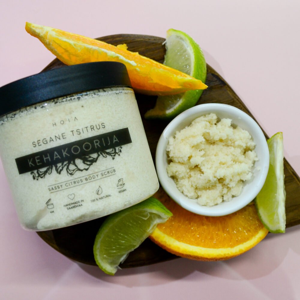 2. HOIA homespa Sassy Citrus body scrub jar with citrus slices and a bowl of scrub, showcasing exfoliating texture and vibrant ingredients