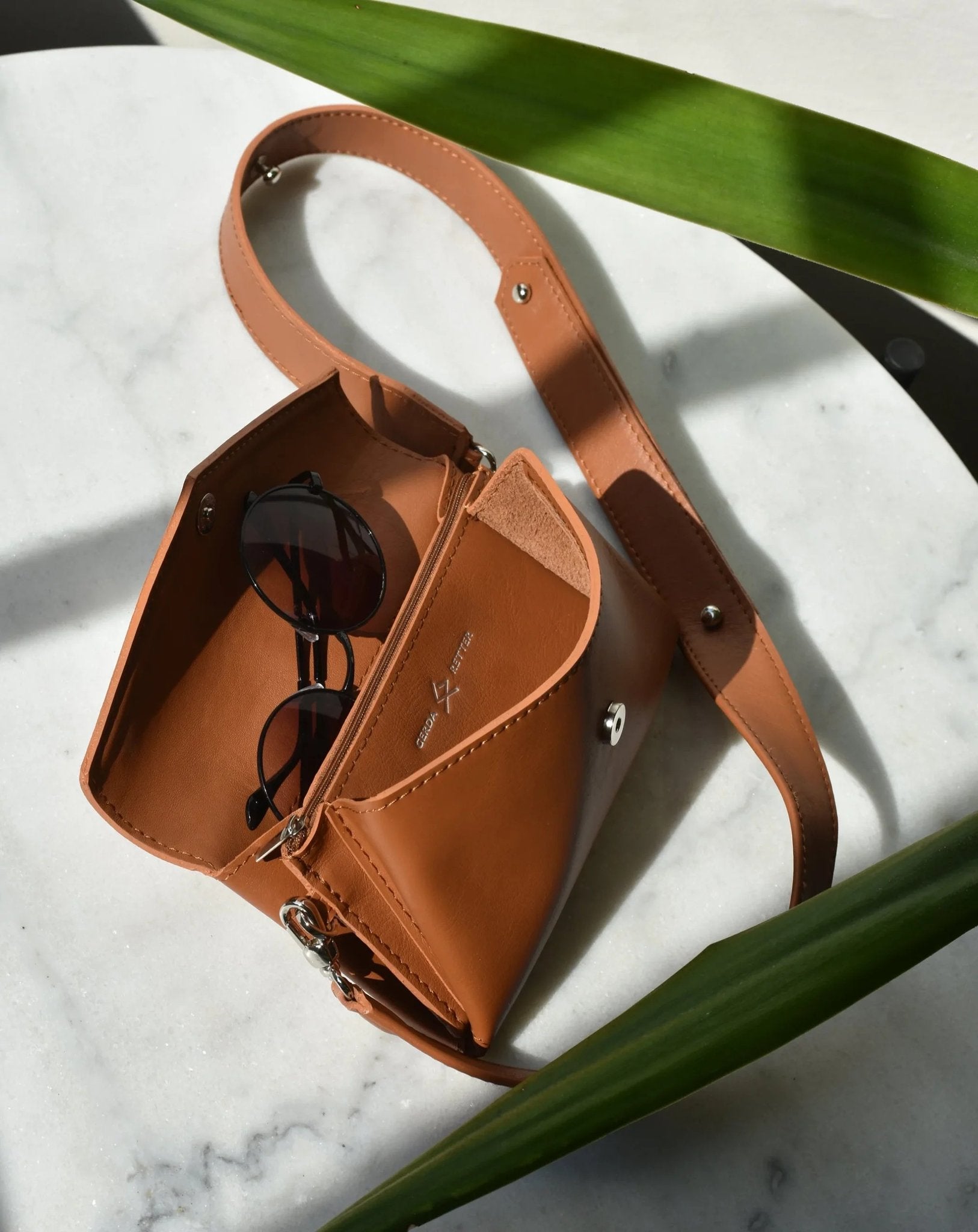 8. Open brown leather waist and shoulder bag by Gerda Retter Design, showing interior pockets