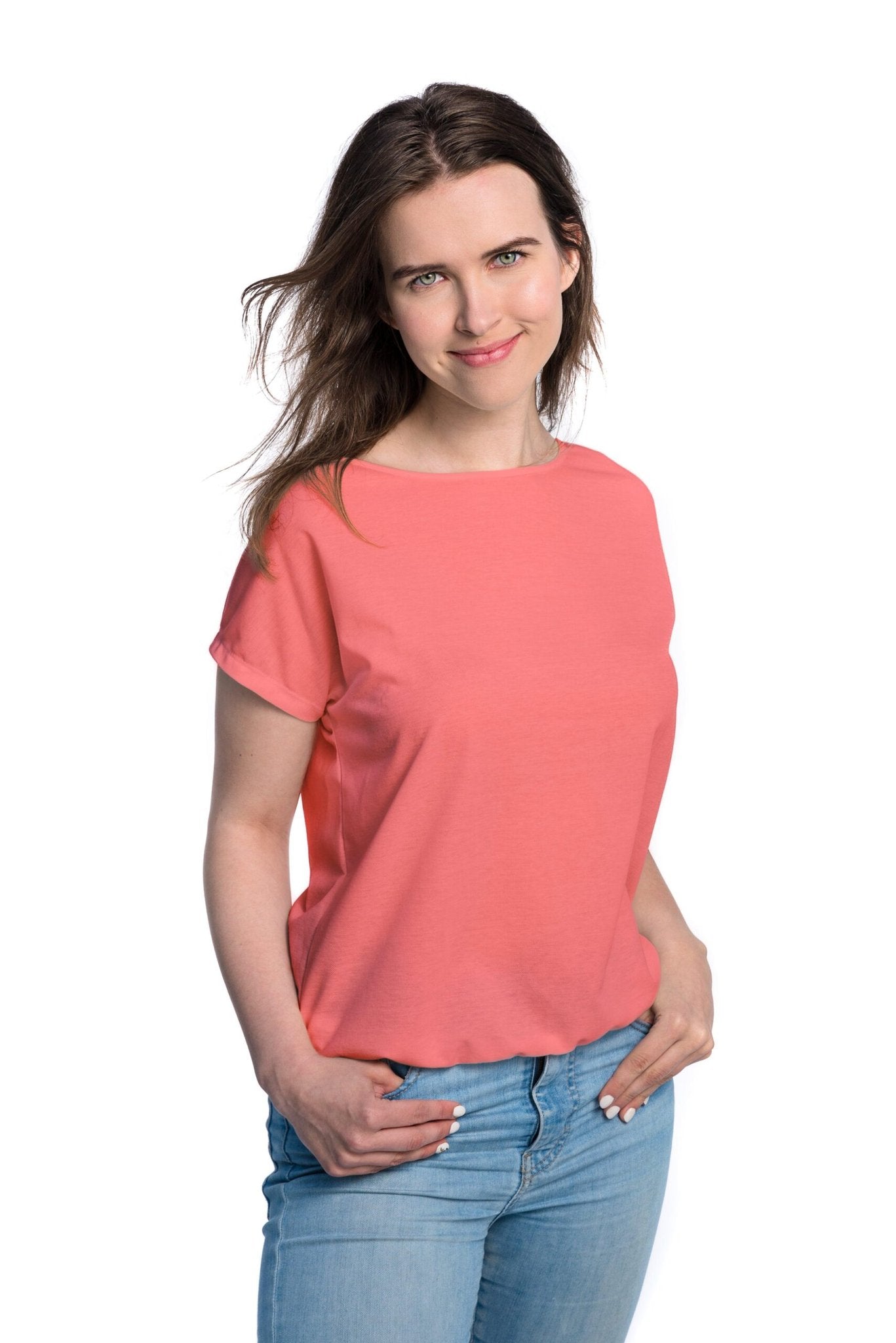 3. Studio shot of woman wearing Smarttan Tan-Through T-Shirt in coral, showing front view and casual fit