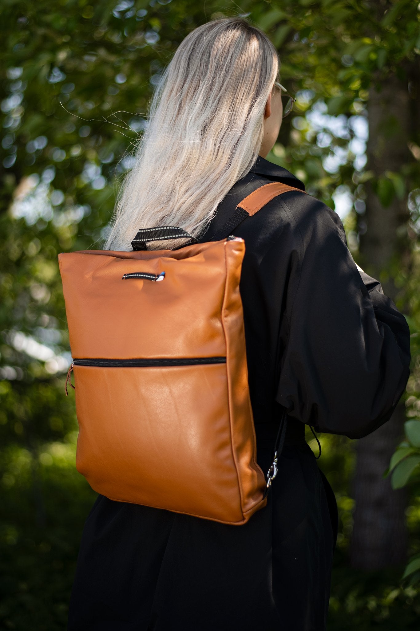 1. Woman wearing Trendbag Barbara Leather Backpack in Calvados, outdoor lifestyle setting