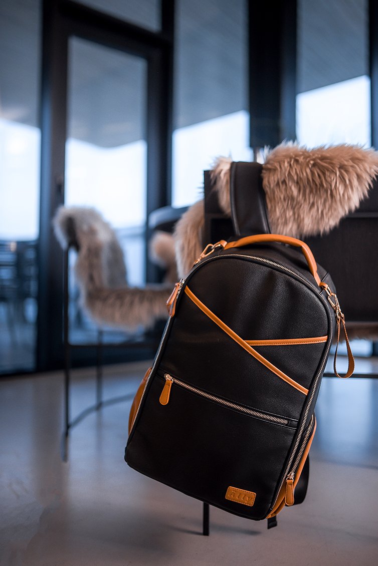 4. Close-up of Ally Scandic Black Coffee diaper backpack on chair, highlighting design