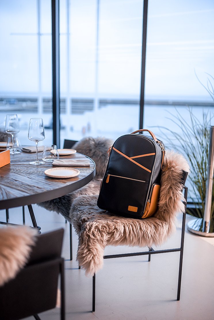 3. Ally Scandic Black Coffee diaper backpack on chair in stylish dining setting