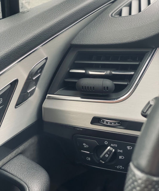 2. Close-up of Candledust Champagne Rhubarb car diffuser attached to car vent, highlighting compact style