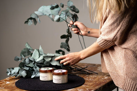 2. BONOBO scented candles Lavandula and Kadakas styled with eucalyptus branches on a wooden table