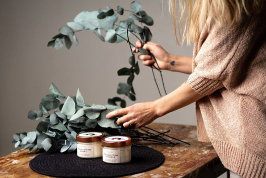 2. BONOBO scented candles Lavandula and Kadakas styled with eucalyptus branches on a wooden table