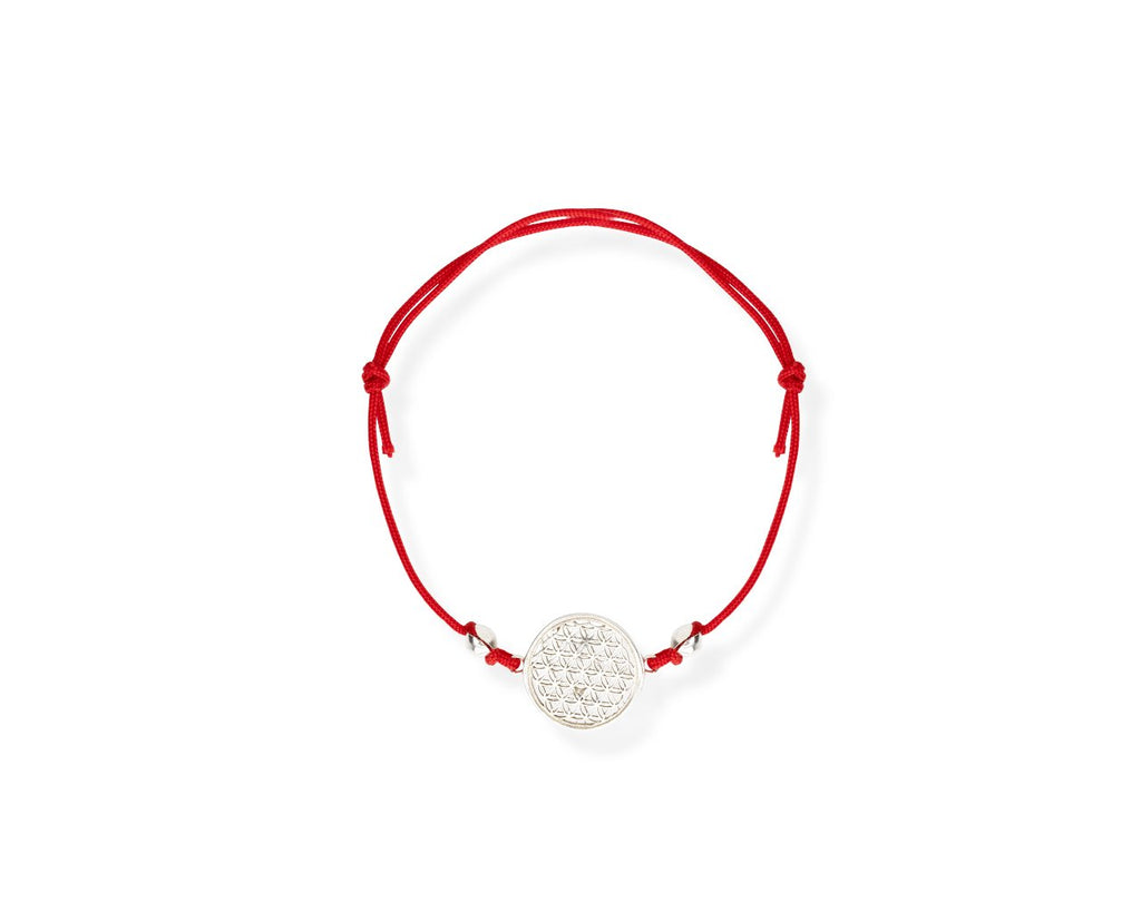 2. Studio image of New Vintage by Kriss Flower Of Life Bracelet with red cord and silver charm, showcasing intricate design