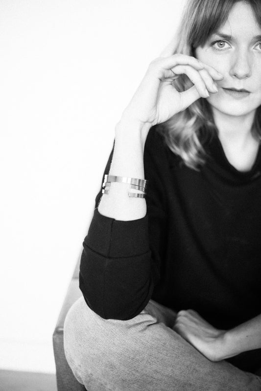 1. Woman wearing Lentsius Exo bracelet in lifestyle setting, showcasing modern eco-conscious design