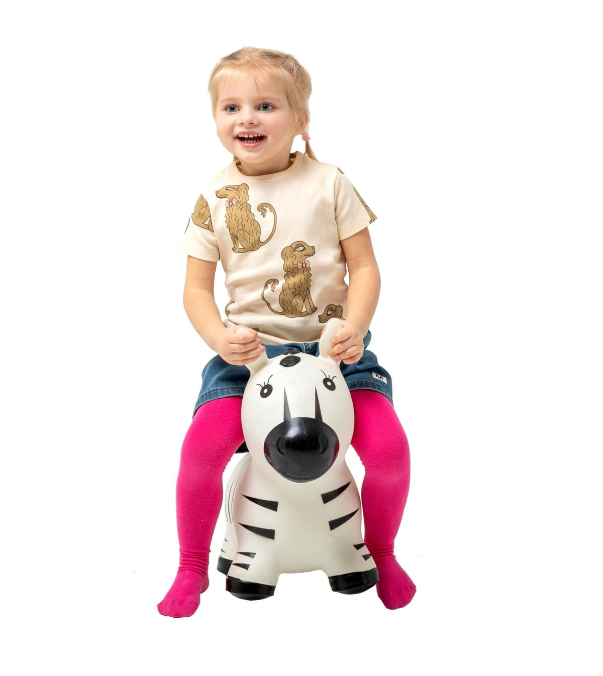 1. Young girl sitting on zebra-shaped hopper toy, wearing beige shirt with animal print and pink leggings