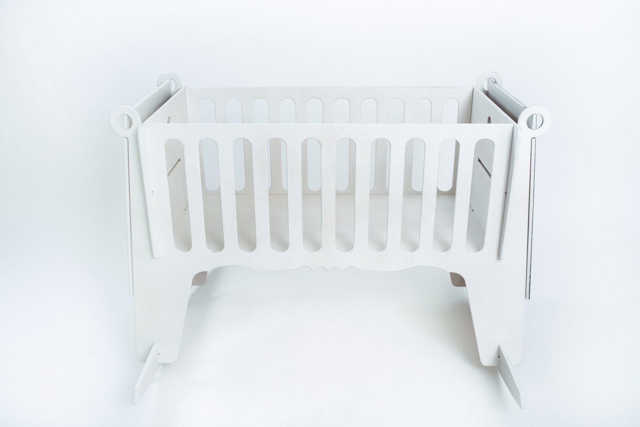 2. White Adensen birchwood baby cradle with slatted sides on white background