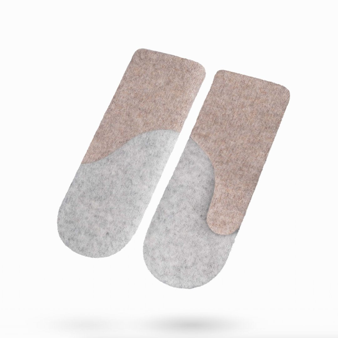 1. Studio shot of HERTTA felted wool mittens in beige and black, showcasing the unique color block design