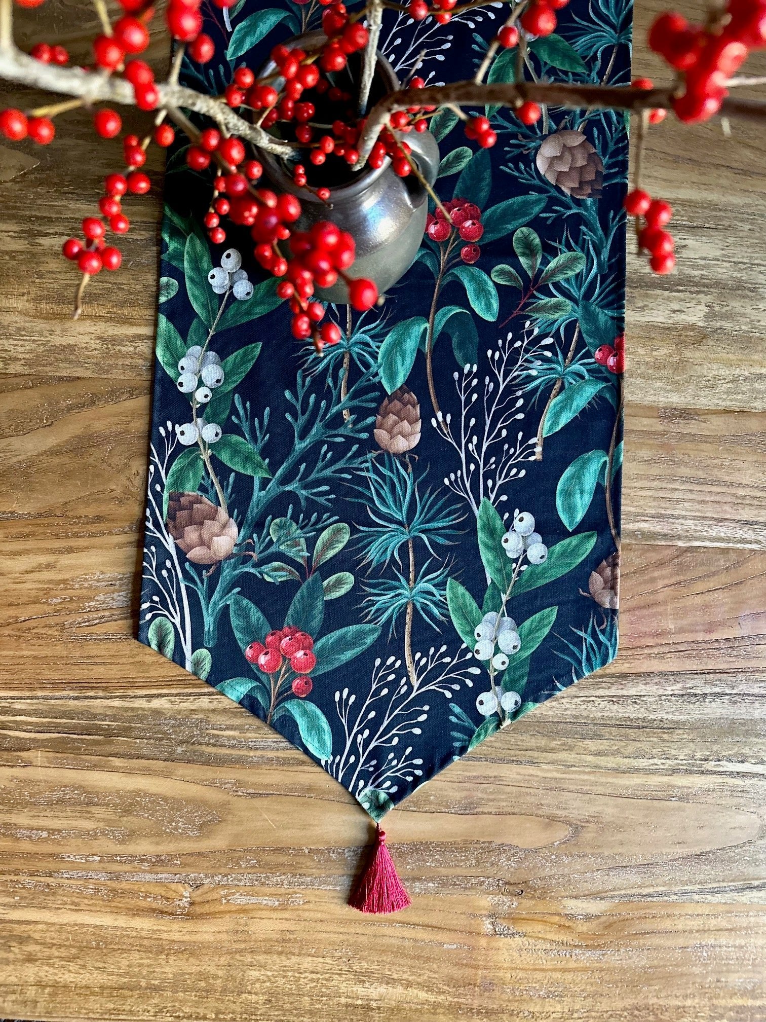 2. Close-up of Christmas Forest Table Runner with tassel detail and festive botanical pattern