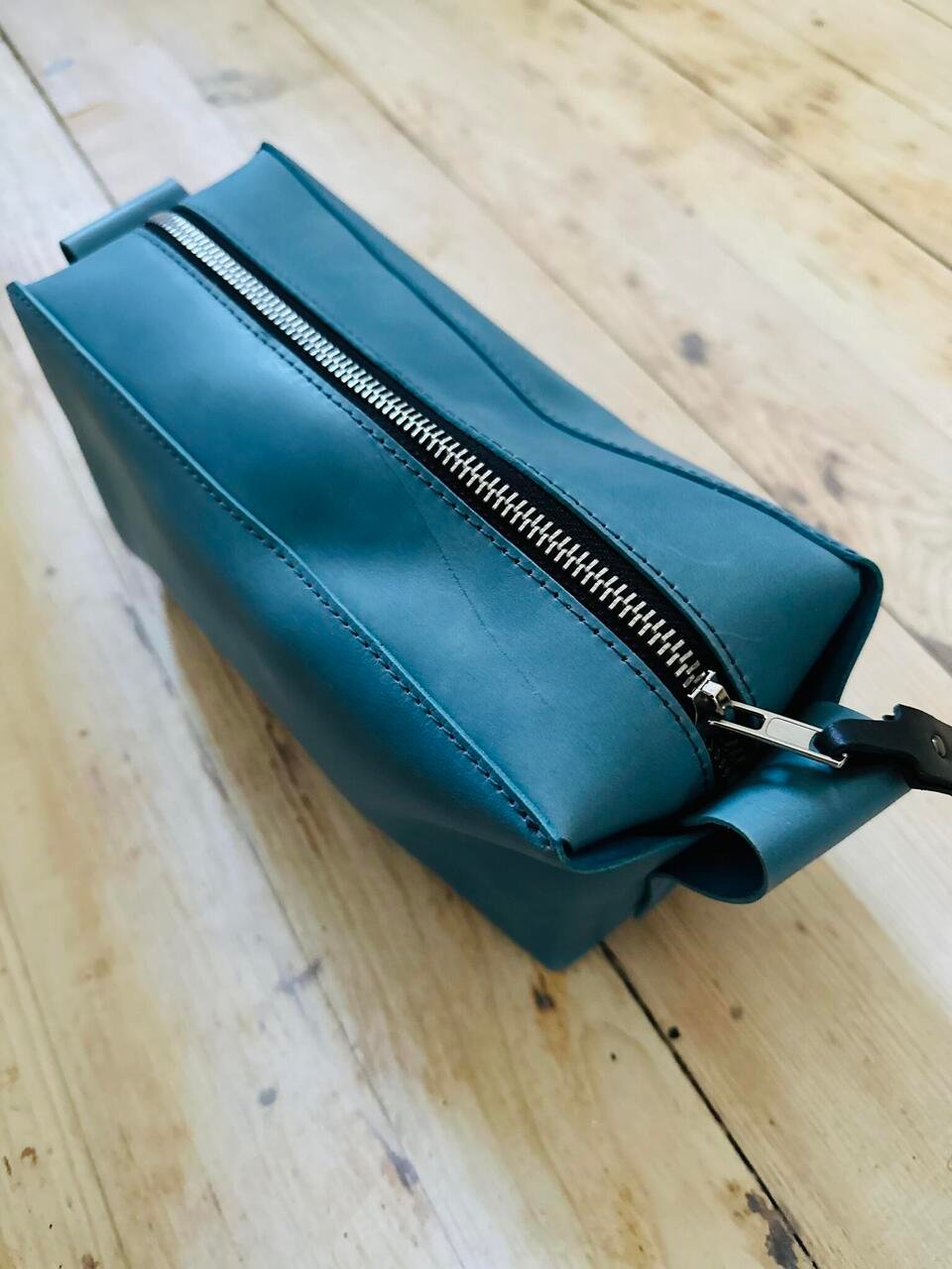 6. Top view of eleriinseim leather cosmetic bag in Atlantico color with zippered closure