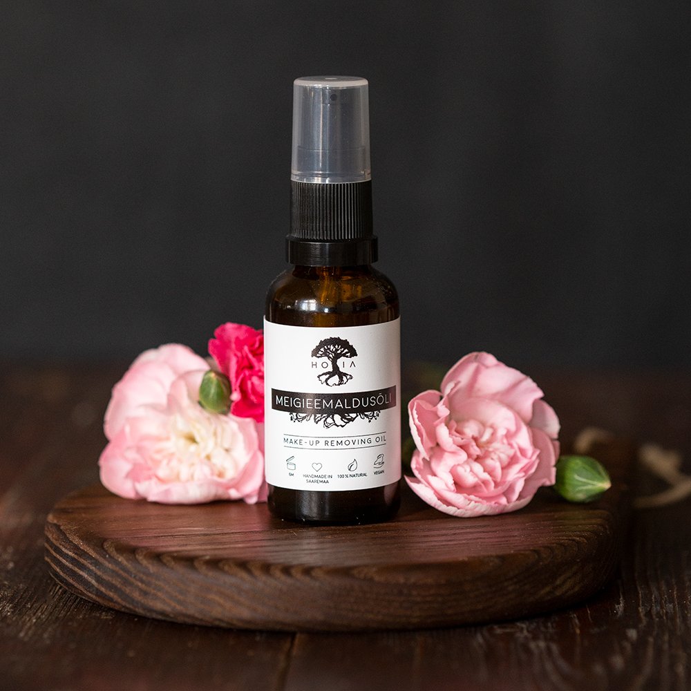 3. HOIA homespa organic make-up removing oil bottle displayed with pink flowers on wooden surface