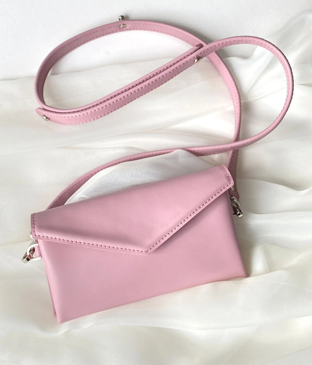 11. Pink leather waist and shoulder bag by Gerda Retter Design, shown on white fabric