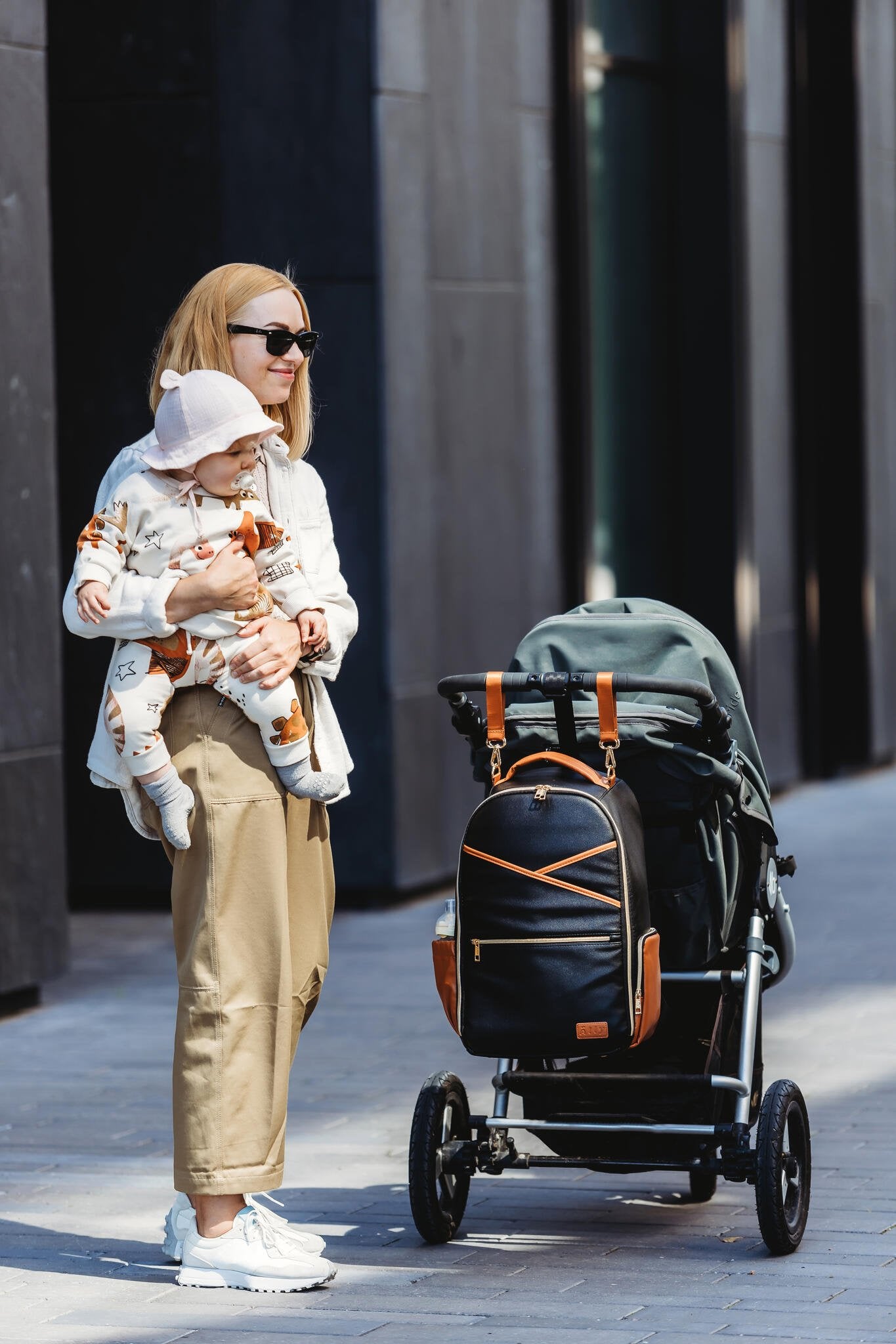 8. Woman with baby and stroller, Ally Scandic Black Coffee diaper backpack attached