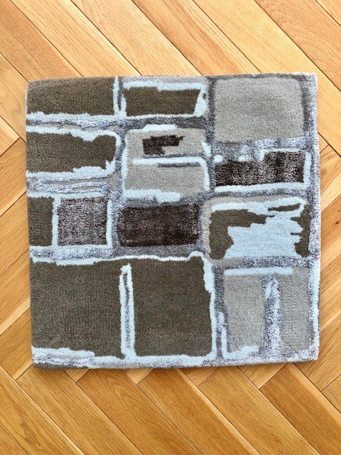 1. Square section of Mondrian in Earthy Hues rug on wooden floor showing mosaic-style pattern in brown and grey tones
