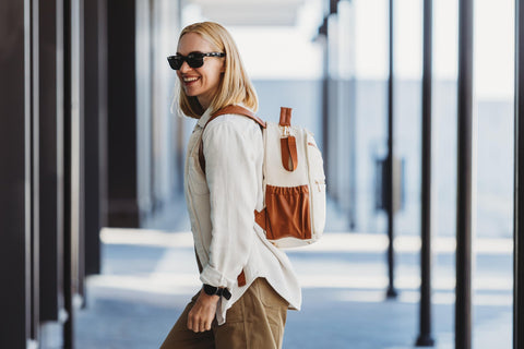 1. Woman wearing Ally Scandic small cappuccino diaper backpack while walking with stroller