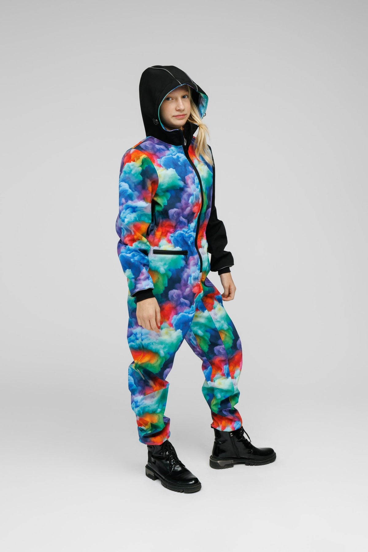 5. Child wearing colorful softshell onesie with hood up, standing on white background