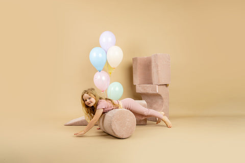 1. Girl in yellow dress playing on powder pink velvet corduroy shape set with balloons