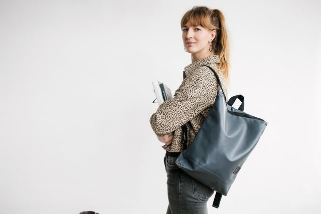 8. Studio shot of Muni faux leather grey backpack showing front design