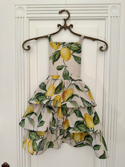 1. Ladies apron with ruffles in lemon print, displayed on hanger, Hortensias Home