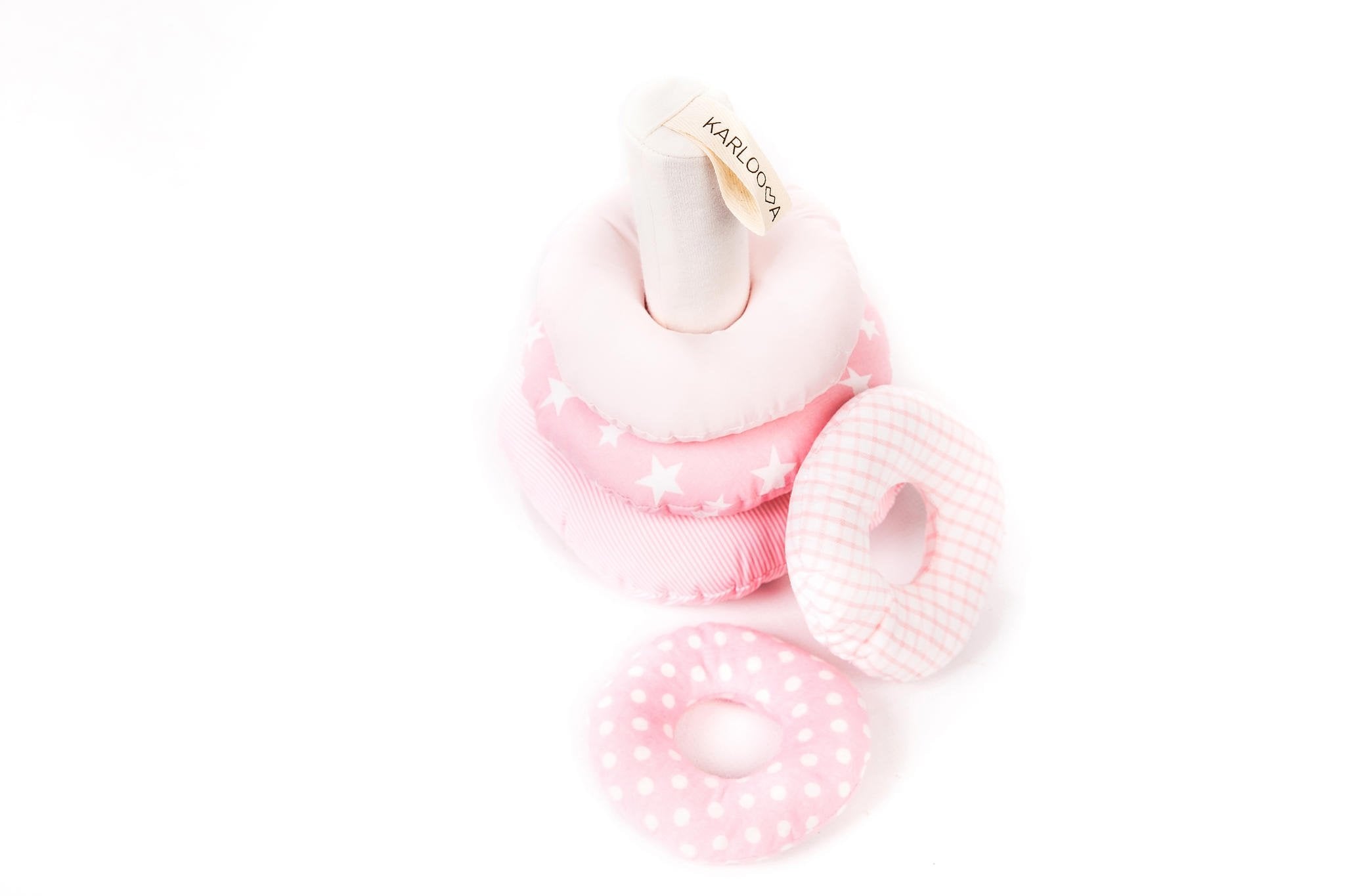 2. Pink Karloova stacking tower with rings laid flat showing various patterns