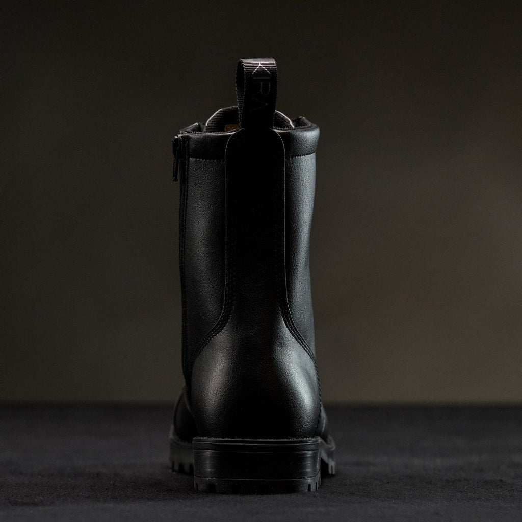 3. Back view of KIRA 6.0 black boots highlighting pull tab and sleek design, studio shot