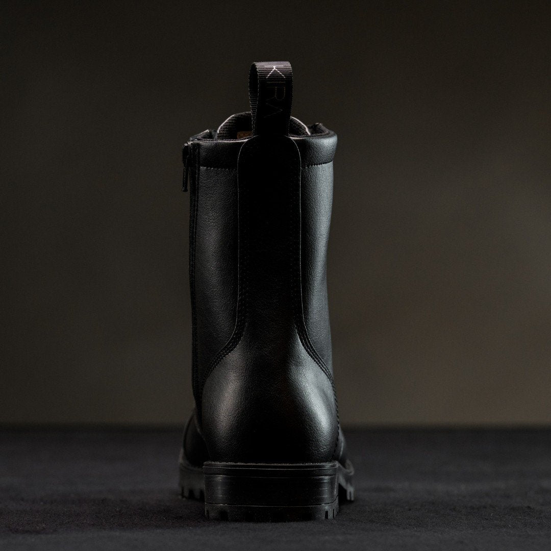 3. Back view of KIRA 6.0 black boots highlighting pull tab and sleek design, studio shot