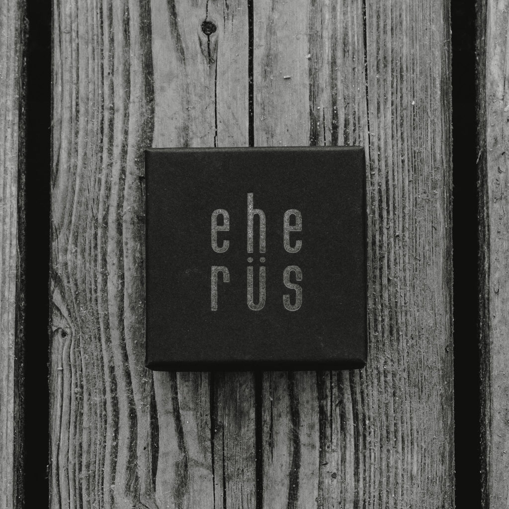 2. Black gift box with Eherüs logo on wooden background