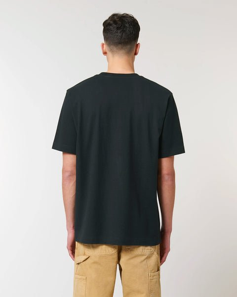1. Man wearing black unisex t-shirt shown from back, highlighting slightly rough fabric texture and set-in sleeves