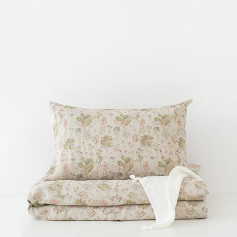 2. Kids' linen duvet cover set with botanical print, pillow and duvet folded on white background