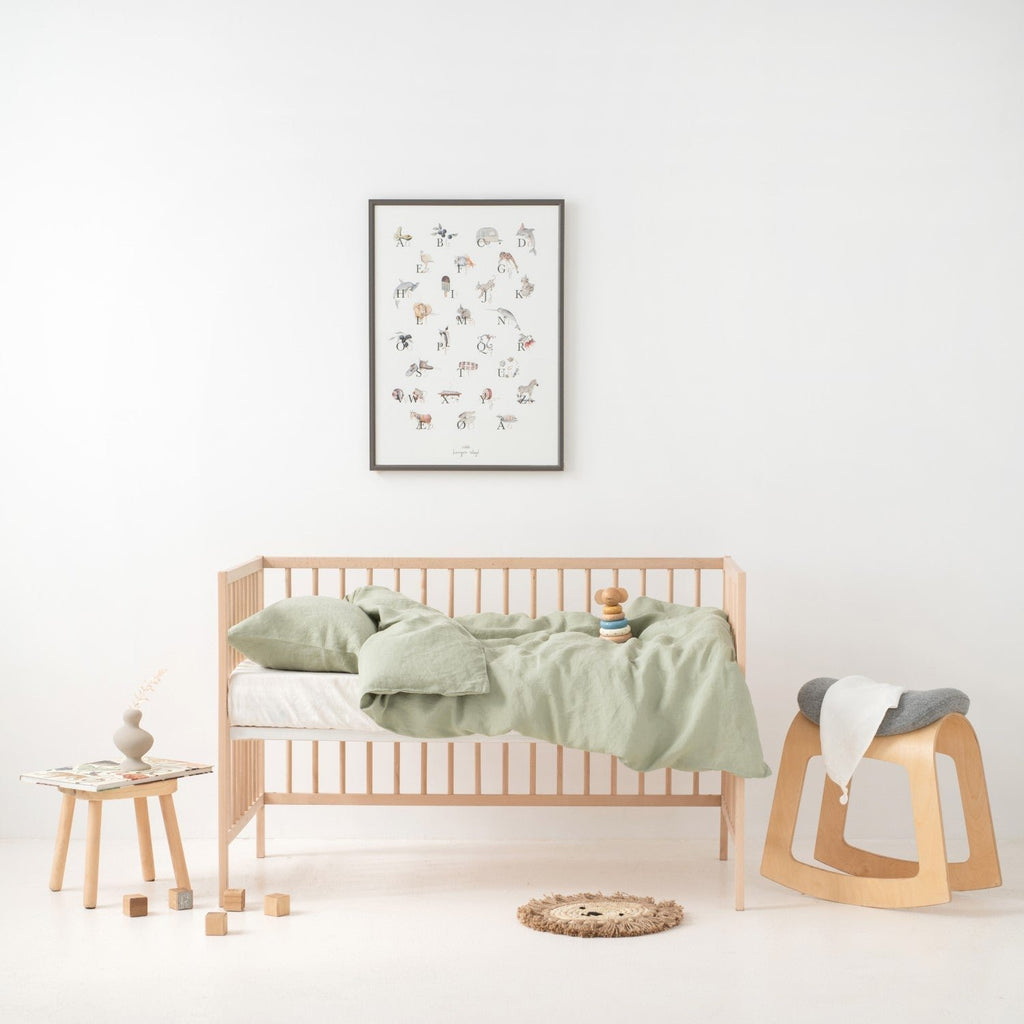 6. Kids' room with crib featuring sage green linen duvet cover set, wooden toys, and decor