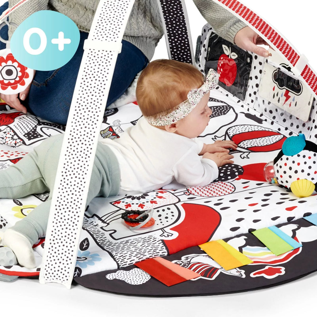 2. Baby playing on Kinderkraft 4SMART sensory mat with colorful ribbons and toys