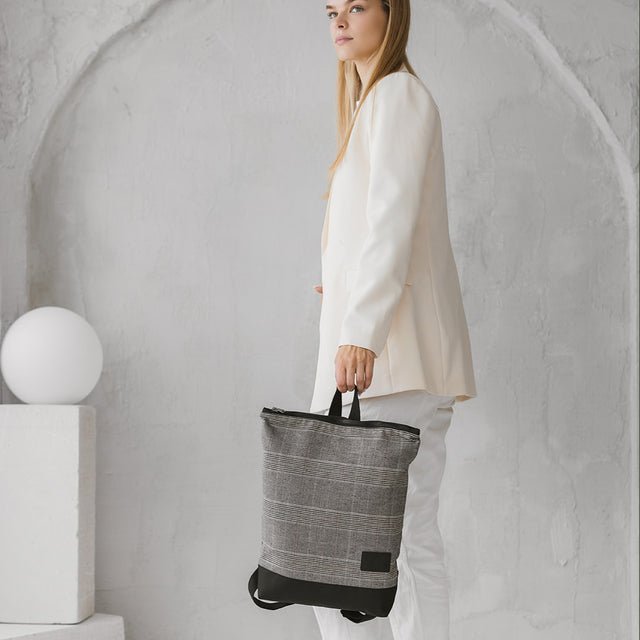 3. Woman carrying MUNI Tartan Backpack, emphasizing adjustable straps and comfort