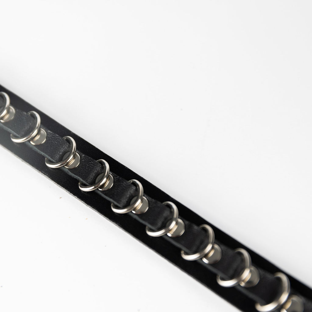 4. Detailed view of metal chain design on PYKOK Lila Mini handbag strap