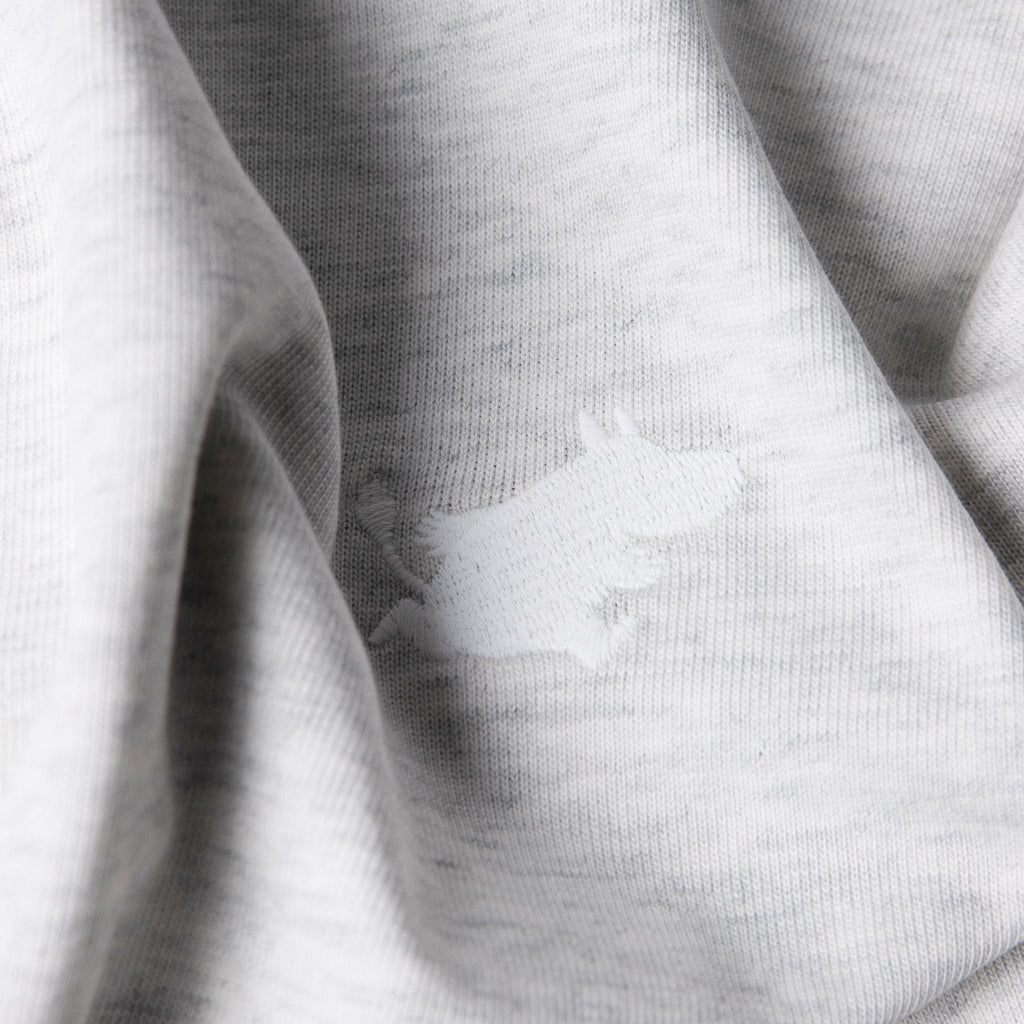 8. Close-up of Moomin Classics heavy T-shirt fabric in melange grey with logo detail