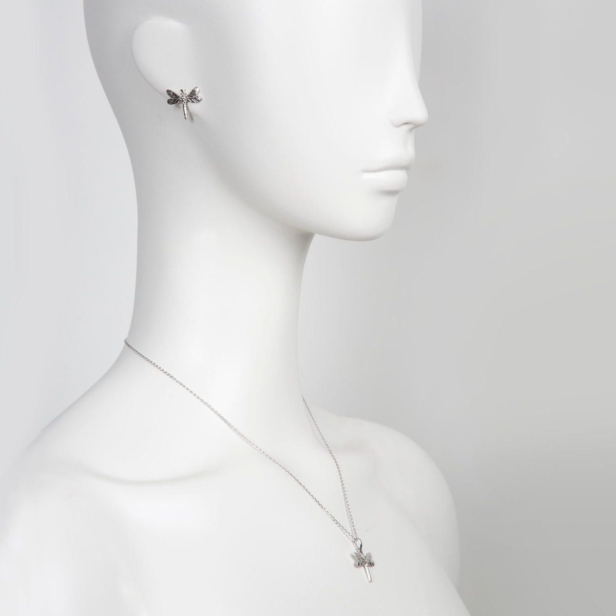 1. Mannequin wearing silver dragonfly pendant necklace and matching earring, highlighting elegant design and craftsmanship