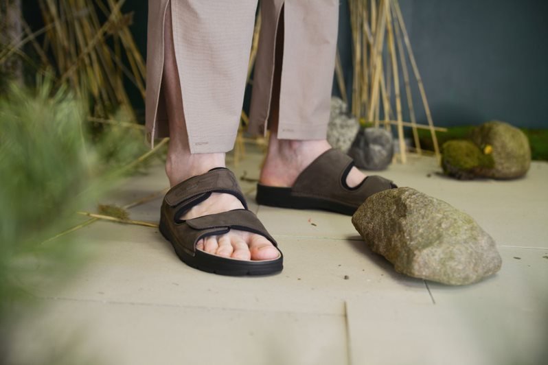 1. Men's Madise Sandals in brown by OmaKing, worn outdoors on rocky terrain