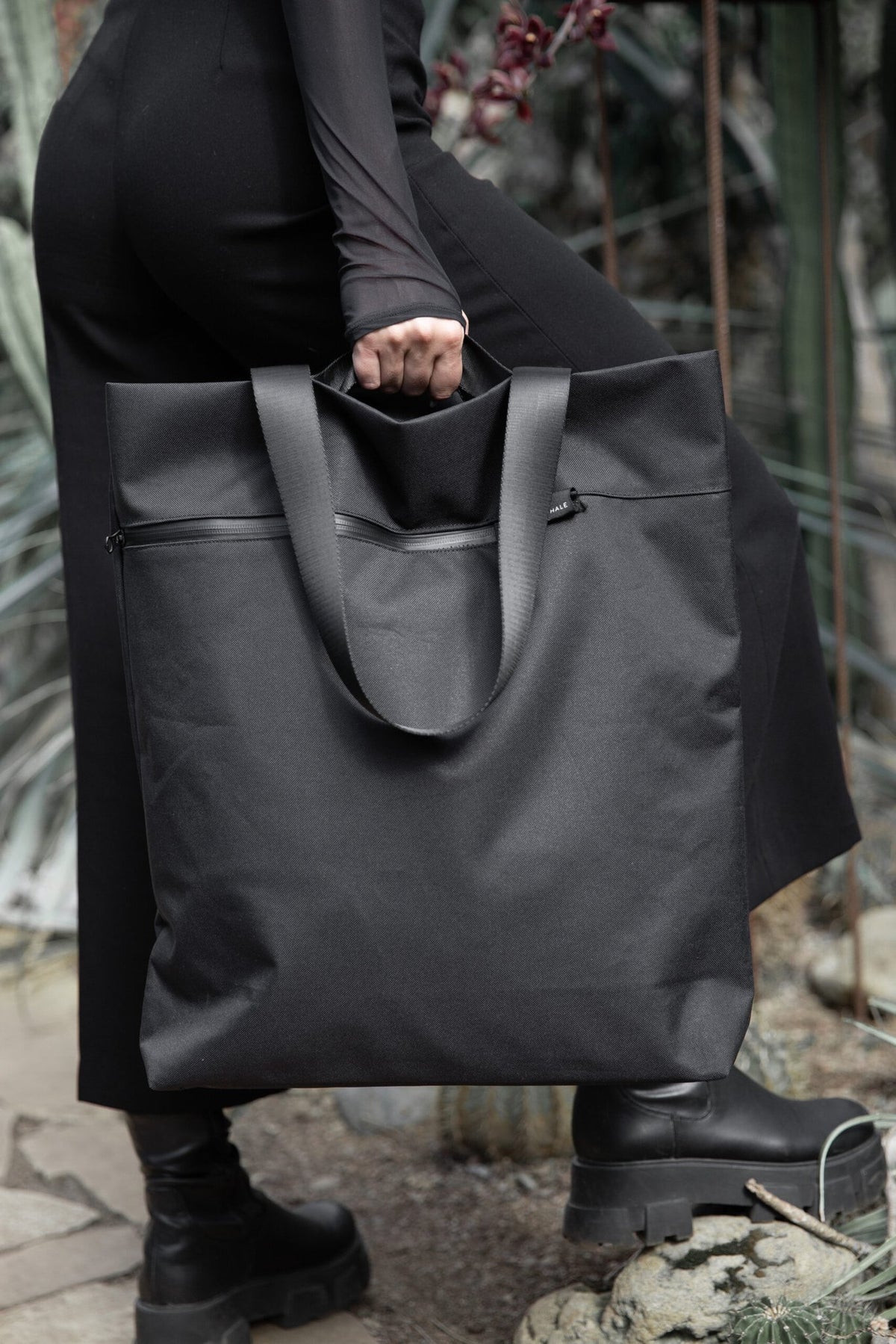 12. Woman walking with Nordhale VIK Tote Bag in black, illustrating its functionality and style