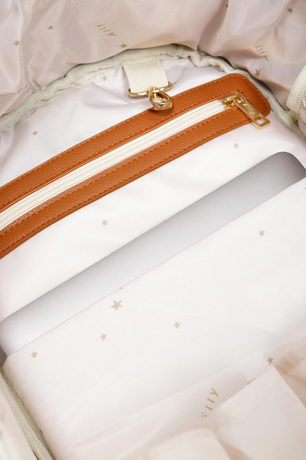 16. Close-up of bottom studs on Ally Scandic small cappuccino diaper backpack