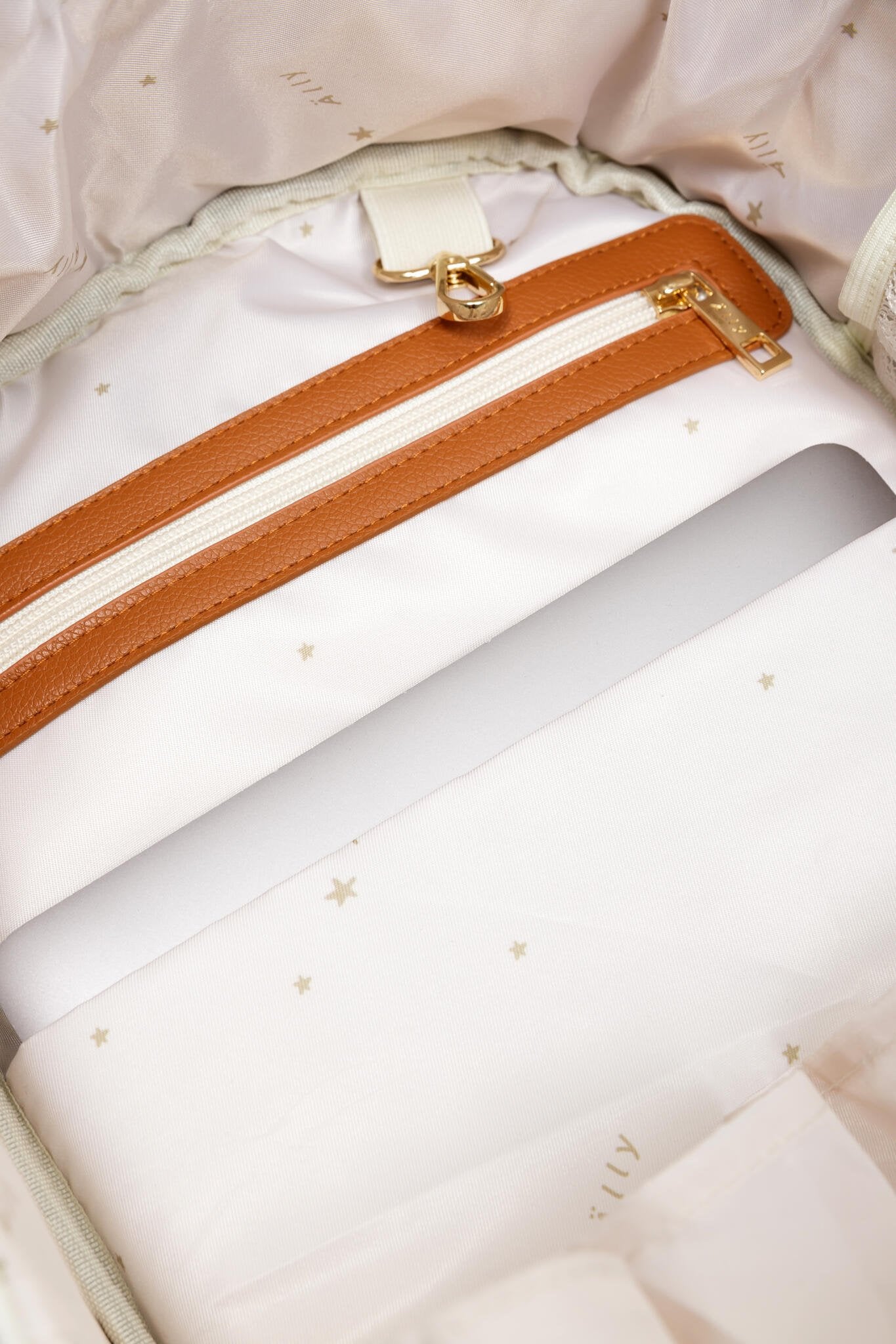 16. Close-up of bottom studs on Ally Scandic small cappuccino diaper backpack
