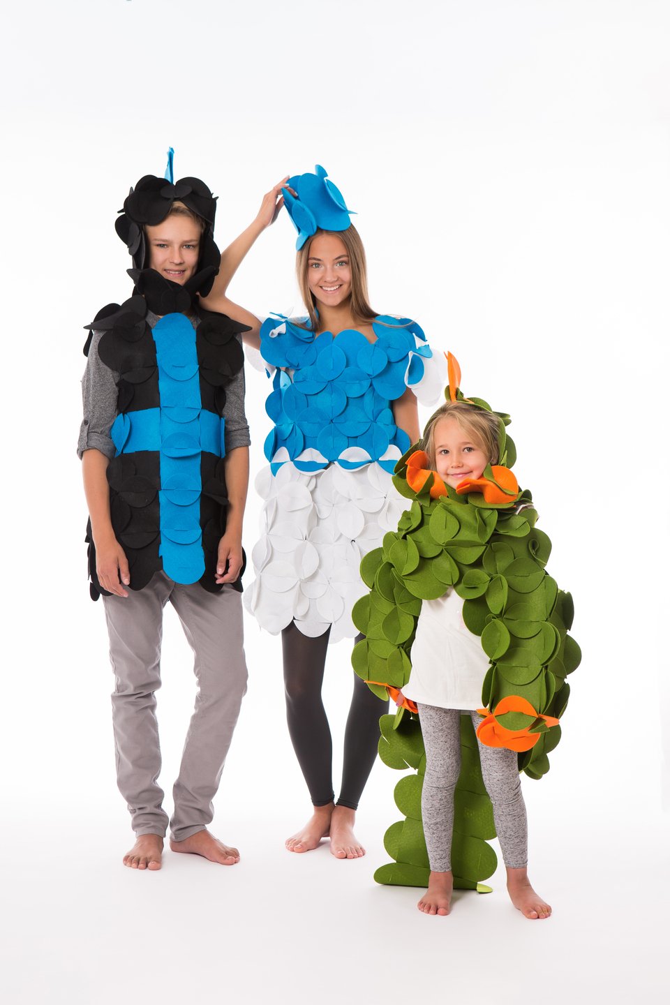 1. Three people in colorful felt costumes, including blue, black, and green designs, smiling on white background